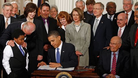 President Obama signs the Affordable Health Care for America Act during a ceremony with fellow Democrats in the White House on March 23, 2010.