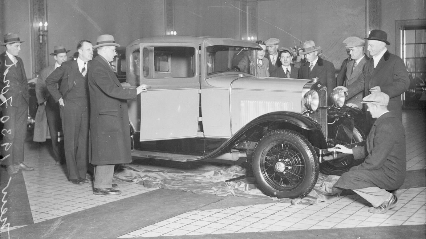 Ford's updated Model A was introduced to the public in late 1927. The anticipation for the car, designed by a group led by Ford's son Edsel, might be compared to the frenzy surrounding a new Apple product: According to Ford News, <a href="http://blog.hemmings.com/index.php/2013/12/02/this-day-in-history-1927-ford-reveals-its-model-a-to-an-eager-public/" target="_blank" target="_blank">more than 10 million people came to look at the car</a> when it went on sale on December 2, 1927. It was still attracting attention in January 1930, when these men came to look one over in Chicago.