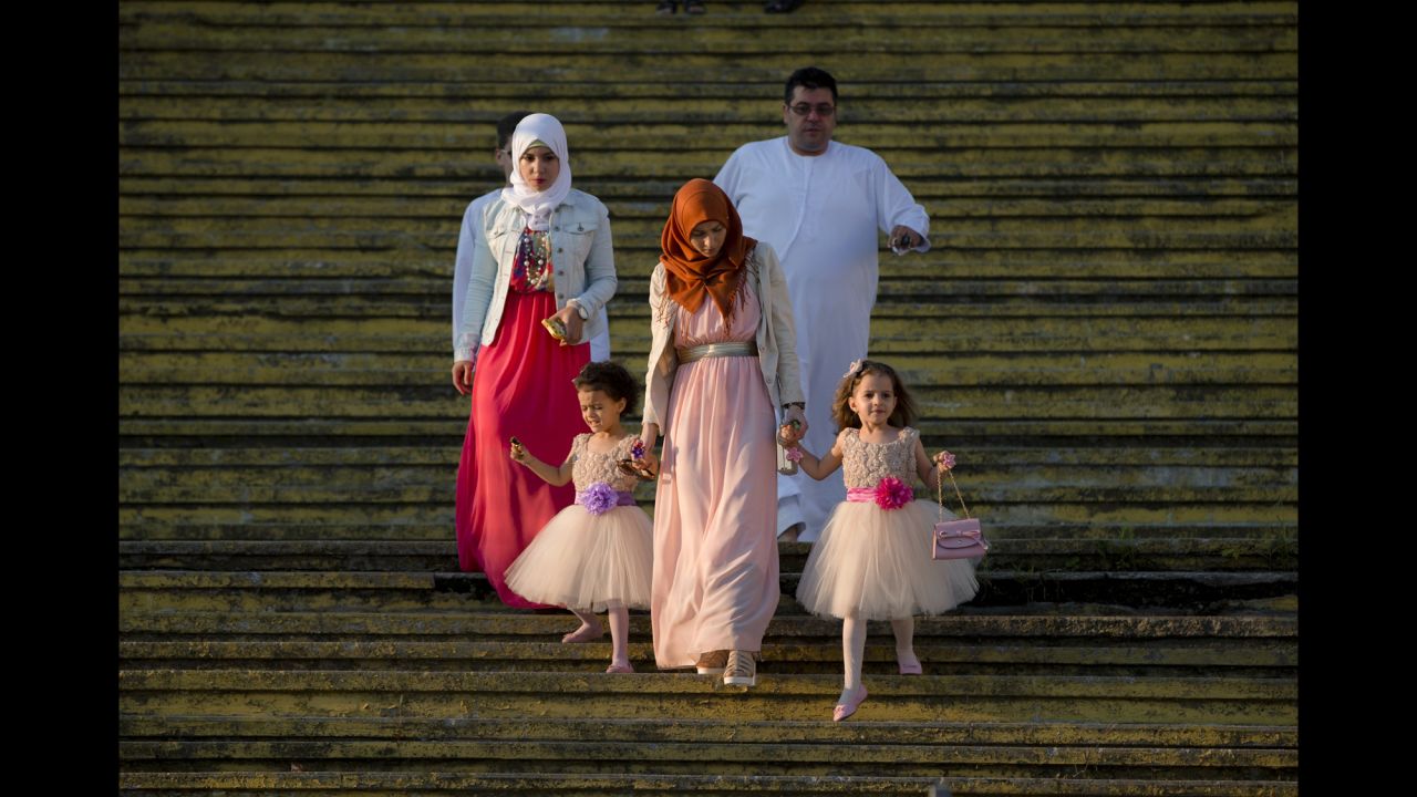 A family arrives for the Eid al-Fitr prayers in Bucharest, Romania, on July 17.