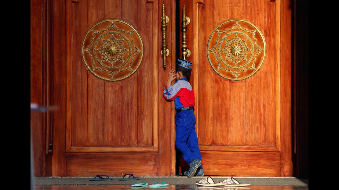 A boy attends the early morning prayer at Al Noor Mosque in Sharjah, UAE.