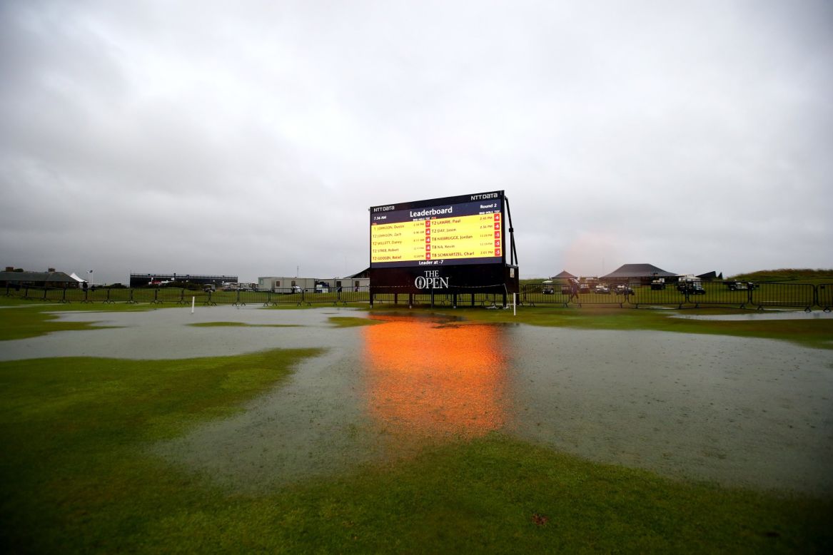 A giant scoreboard illuminates one of the huge puddles that had formed on the Old Course.