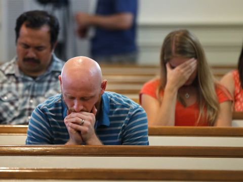The Rev. Drew McCallie prays during a church service in Chattanooga on July 16.