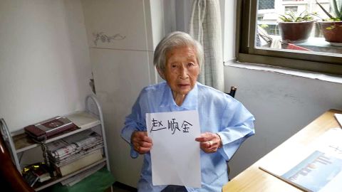 Zhao Shunjin, 100,  holds up a piece of paper with her name written on it in her own handwriting at her home in Hangzhou, China  on July 16, 2015.