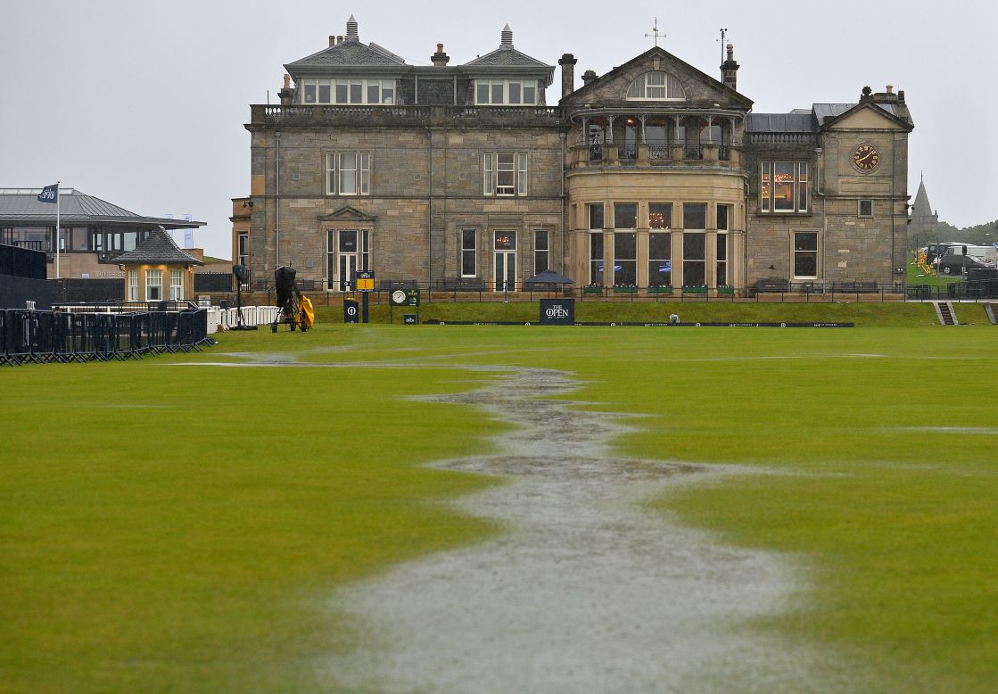 The heavens opened at 5 a.m. (BST) and quickly flooded the course, forming mini rivers in front of the famous old St Andrews clubhouse. 