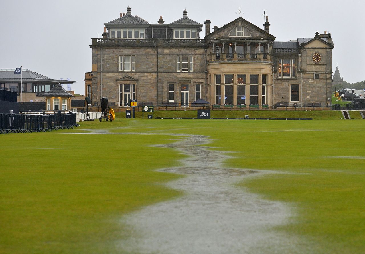 The heavens opened at 5 a.m. (BST) and quickly flooded the course, forming mini rivers in front of the famous old St Andrews clubhouse.