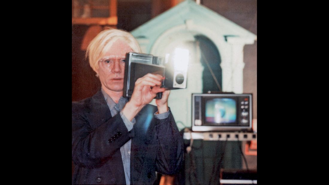 Andy Warhol took hundreds of Polaroids of actors, athletes, musicians and other artists. Here, he stands at The Factory, his New York studio, with a Polaroid Big Shot camera in 1978. He later transposed his Polaroid snapshot onto canvas.