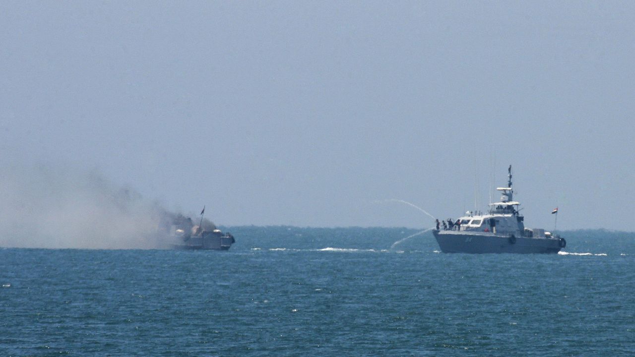 An Egyptian navy vessel hoses down another that caught on fire at the Mediterranean Sea on July 16, 2015.