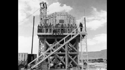 Los Alamos workers pose on a platform stacked with 100 tons of TNT. It was to be used to gauge radioactive fallout. 