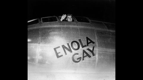 Air Force Col. Paul Tibbetts waves from the pilot's seat of the Enola Gay moments before takeoff on August 6, 1945. A short time later, the plane's crew dropped the first atomic bomb in combat, instantly killing 80,000 people in Hiroshima.
