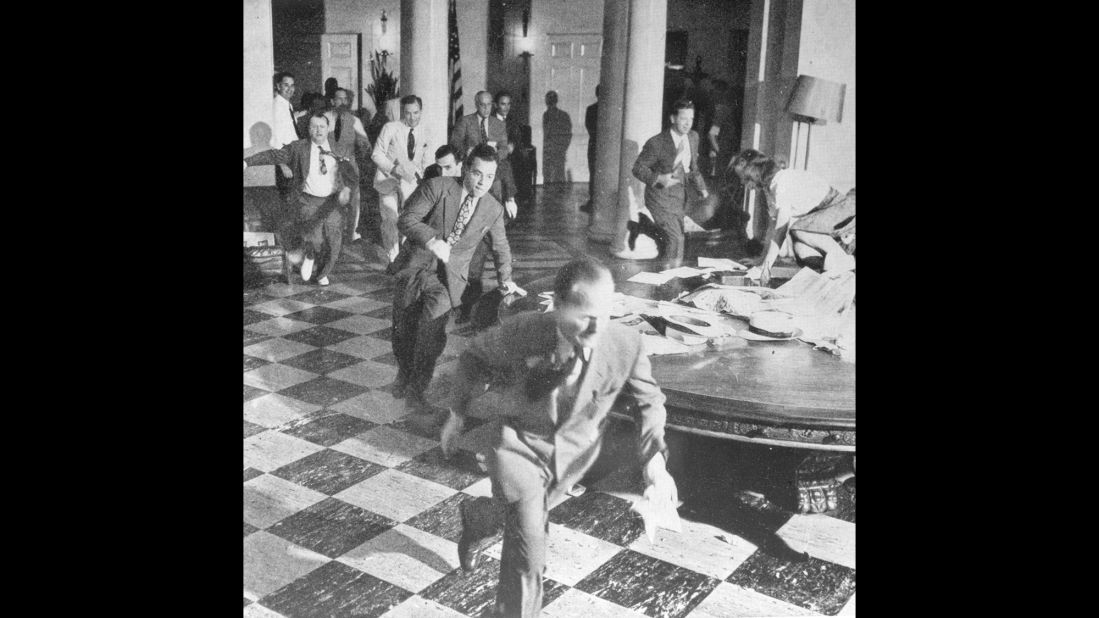 Members of the White House Press Corps rush to telephones after Truman announced Japan's surrender on August 15, 1945.
