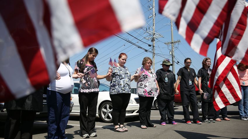 CHATTANOOGA, TN - JULY 17: Miller-Motte Technical College students and others join in prayer across the highway from the strip mall where a gunman attacked the Armed Forces Career Center/National Guard Recruitment Office on July 17, 2015 in Chattanooga, Tennessee. According to reports, Mohammod Youssuf Abdulazeez, 24, opened fire on the military recruiting station at the strip mall on July 16th and then drove to an operational support center operated by the U.S. Navy more than seven miles away and killed four United States Marines there. (Photo by Joe Raedle/Getty Images)