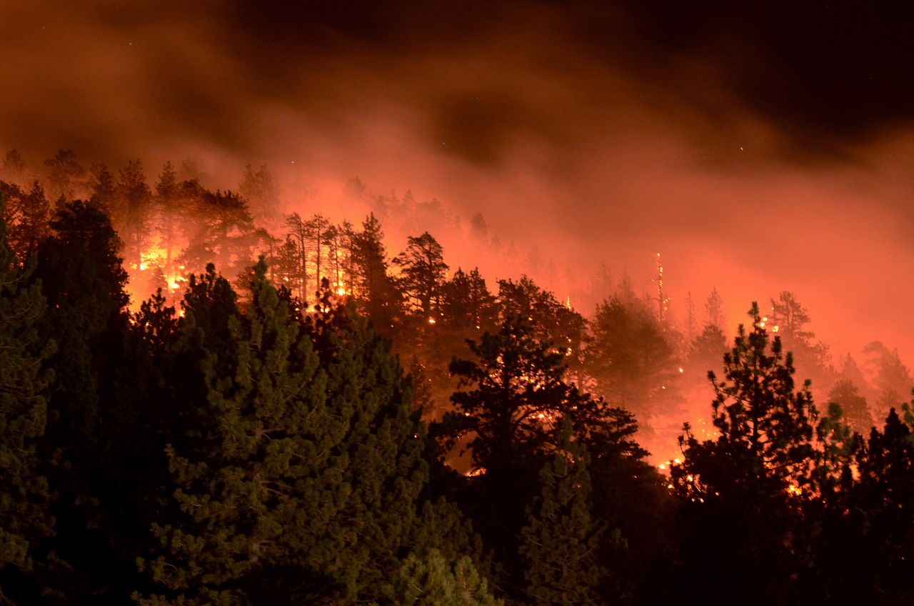 Flames from the Pines Fire burn on Saturday, July 18, in Wrightwood, California. The blaze was burning near Mount San Antonio, which is also called Mount Baldy for its snow-capped summit that's highly visible in Los Angeles.