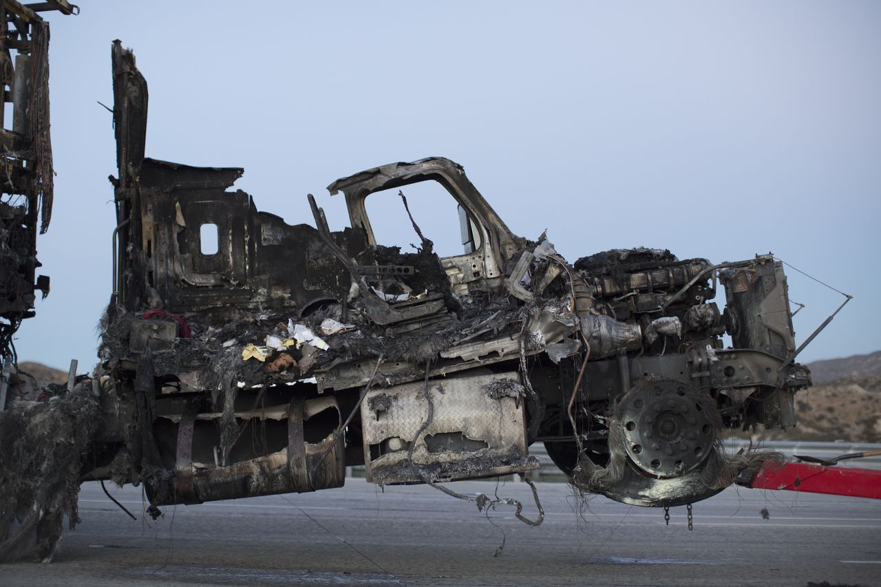 The scorched remains of a truck destroyed by the North Fire are towed away near Victorville on July 17.