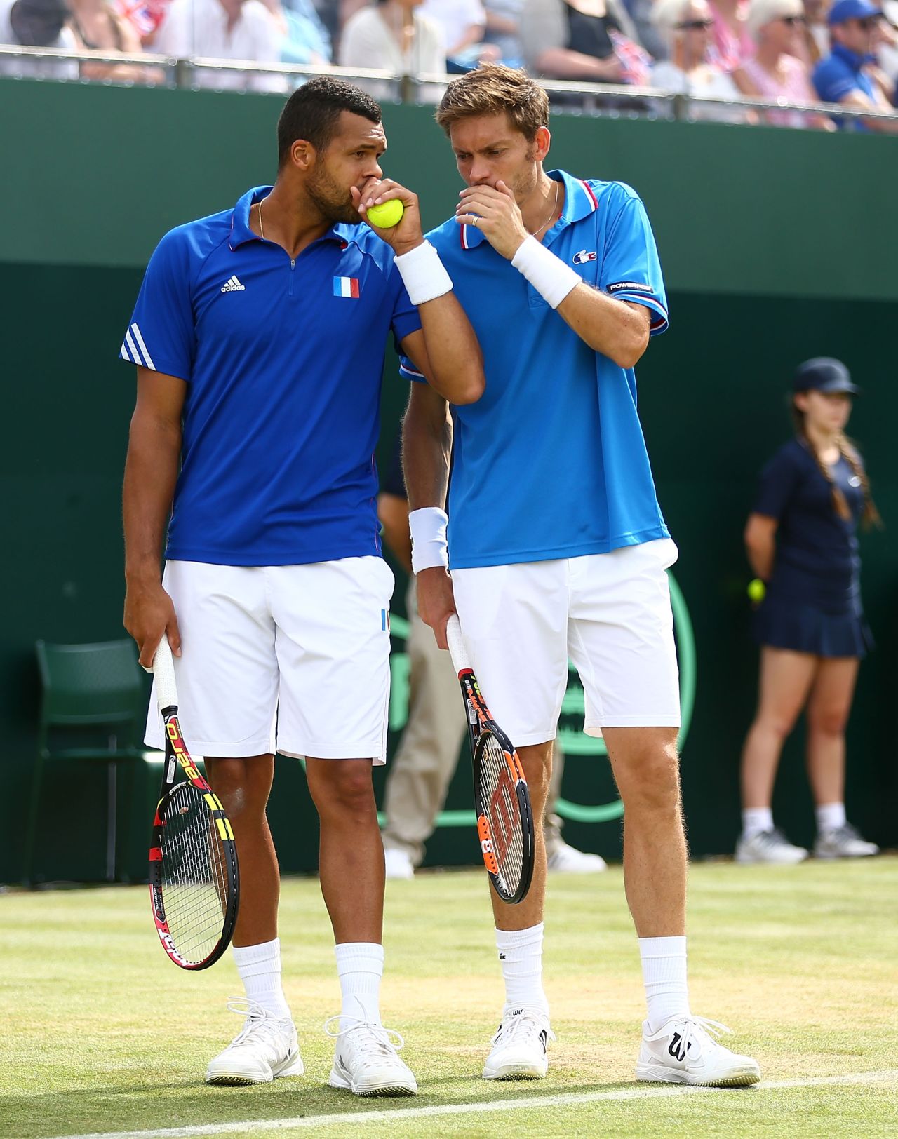 France's Nicolas Mahut (right) and Jo-Wilfried Tsonga (left) discuss tactics during their three-set defeat at London's Queen's Club.