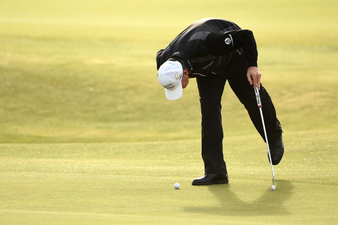 Paul Lawrie, the 1999 Open champion, watches his ball move in the wind. The Scot was third, two behind Johnson and one adrift of England's Danny Willett.
