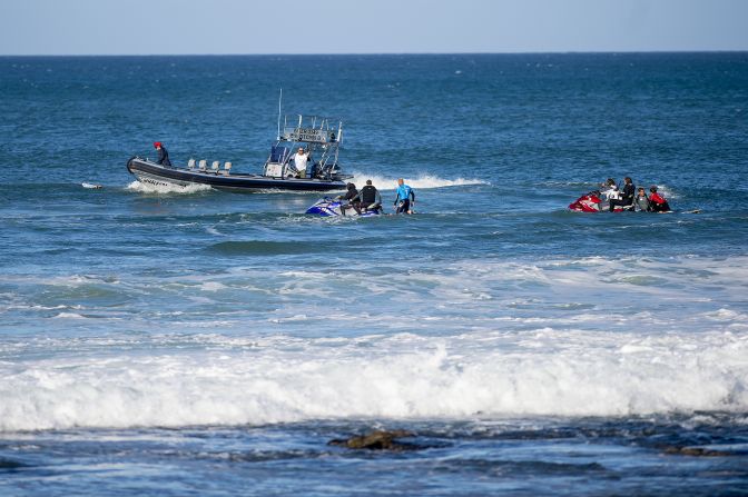 Fanning and Wilson are taken to shore by rescue craft.
