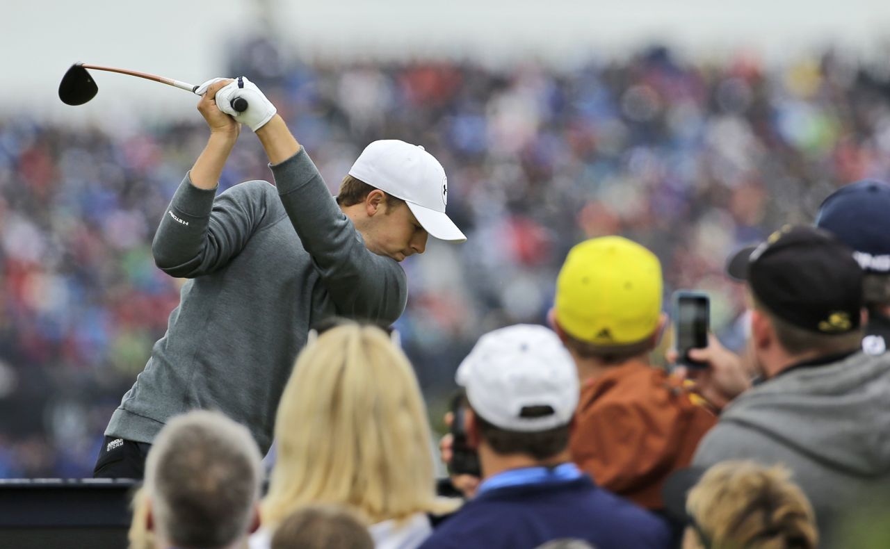 Texan Spieth drives off on the seventh watched by a large gallery.