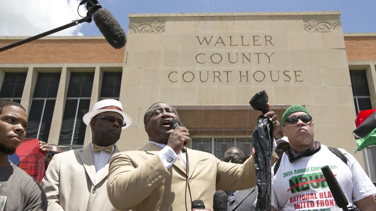Quanell X, leader of the New Black Panther Party, holds a plastic bag while speaking at a rally at the Waller County Courthouse in Hempstead, Texas, on Friday, July 17. Authorities said there were no cameras in Bland's jail cell to show that she hanged herself, but cameras in the hallway show no one entering or leaving the cell before her body was discovered. 