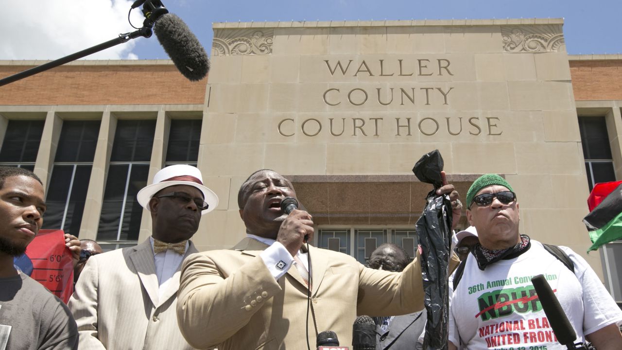 Quanell X, leader of the New Black Panther Party, holds a plastic bag while speaking at a rally at the Waller County Courthouse in Hempstead, Texas, on Friday, July 17. Authorities said there were no cameras in Bland's jail cell to show that she hanged herself, but cameras in the hallway show no one entering or leaving the cell before her body was discovered.