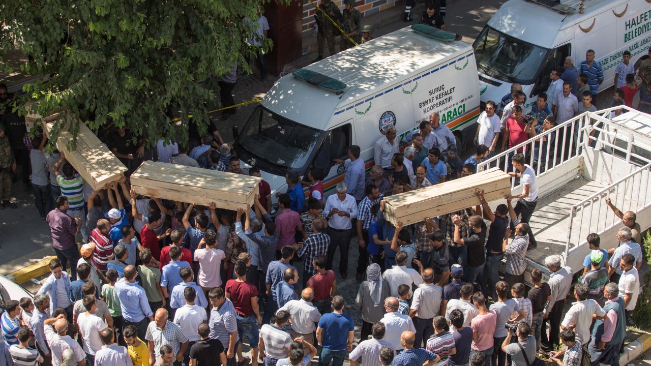 People carry coffins from the scene of the explosion on July 20. 
