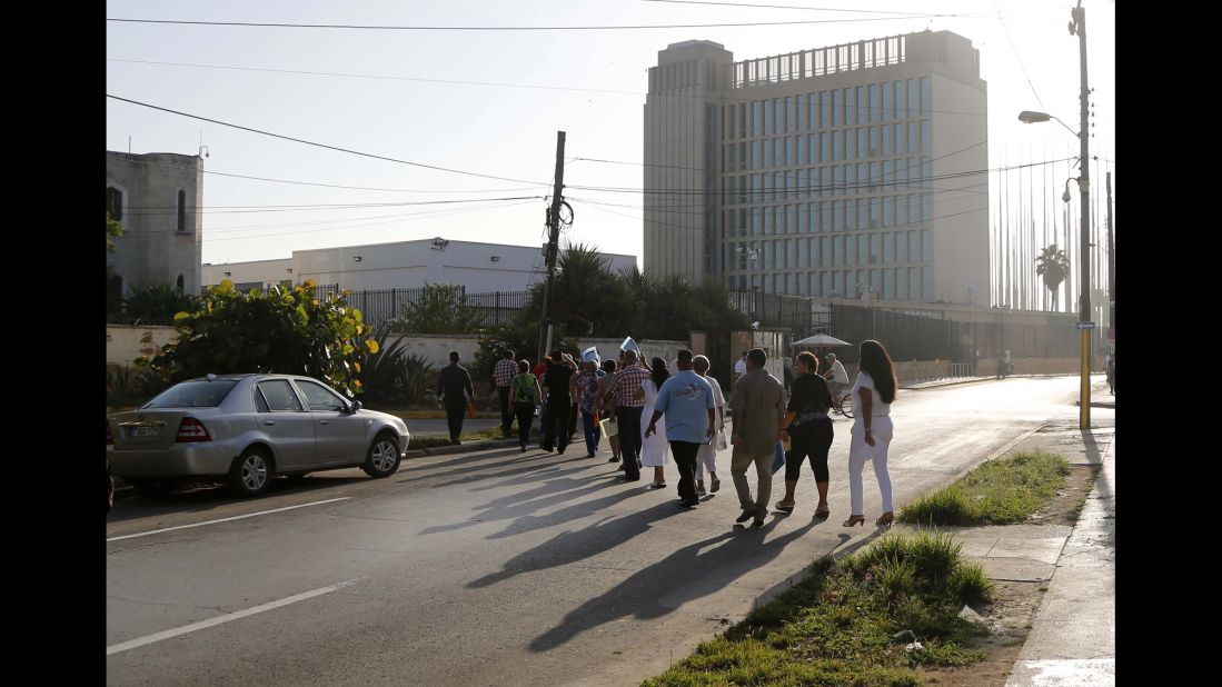 Cubans expecting their visas to the United States cross the street to enter the U.S. Embassy in Havana on July 20.