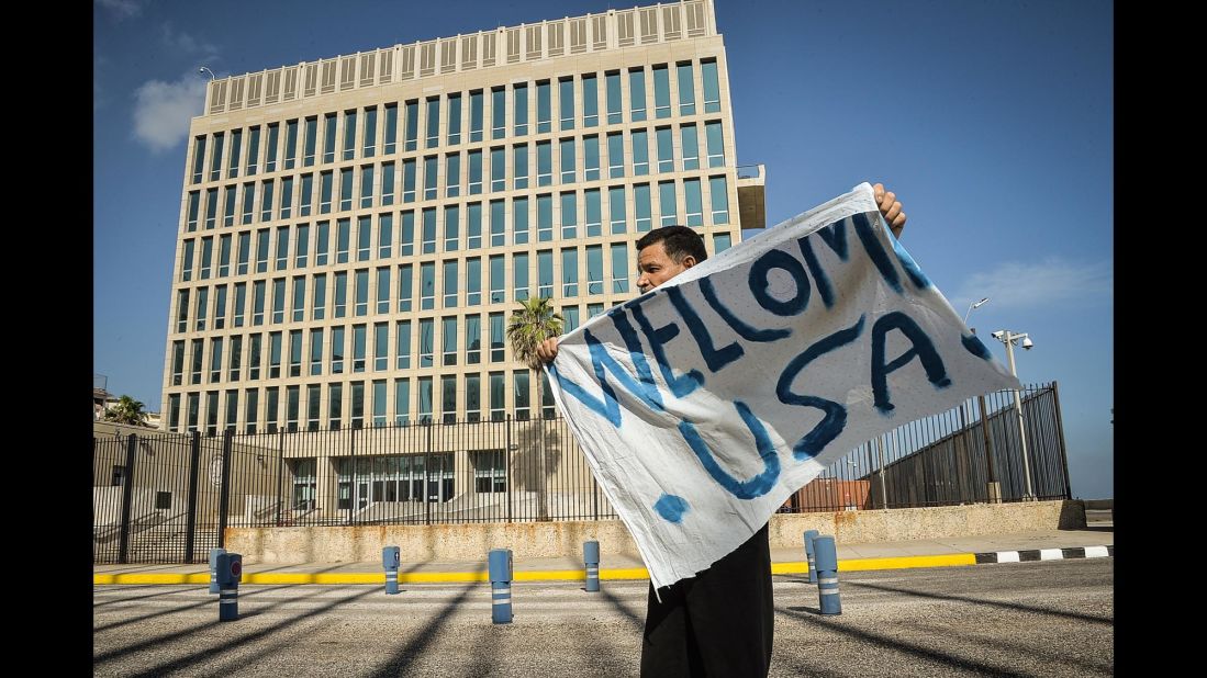 A man waves a banner in front of the U.S. Embassy in Havana on July 20.
