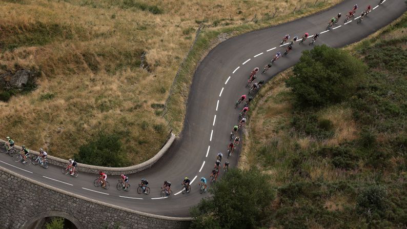 The peloton weaves its way through La Souche, France, during the 15th stage of the Tour de France on Sunday, July 19. The race will conclude July 26 in Paris.