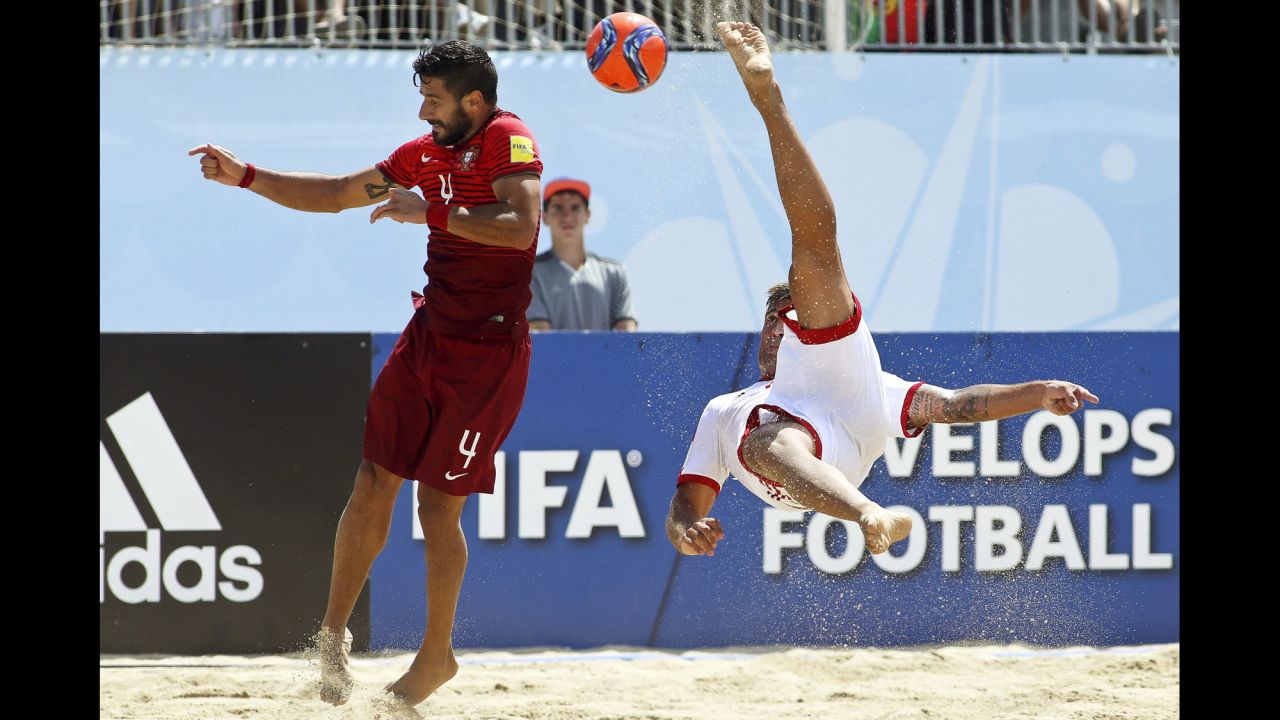 Switzerland's Dejan Stankovic performs an overhead kick near Portugal's Torres during a quarterfinal match at the Beach Soccer World Cup on Thursday, July 16.