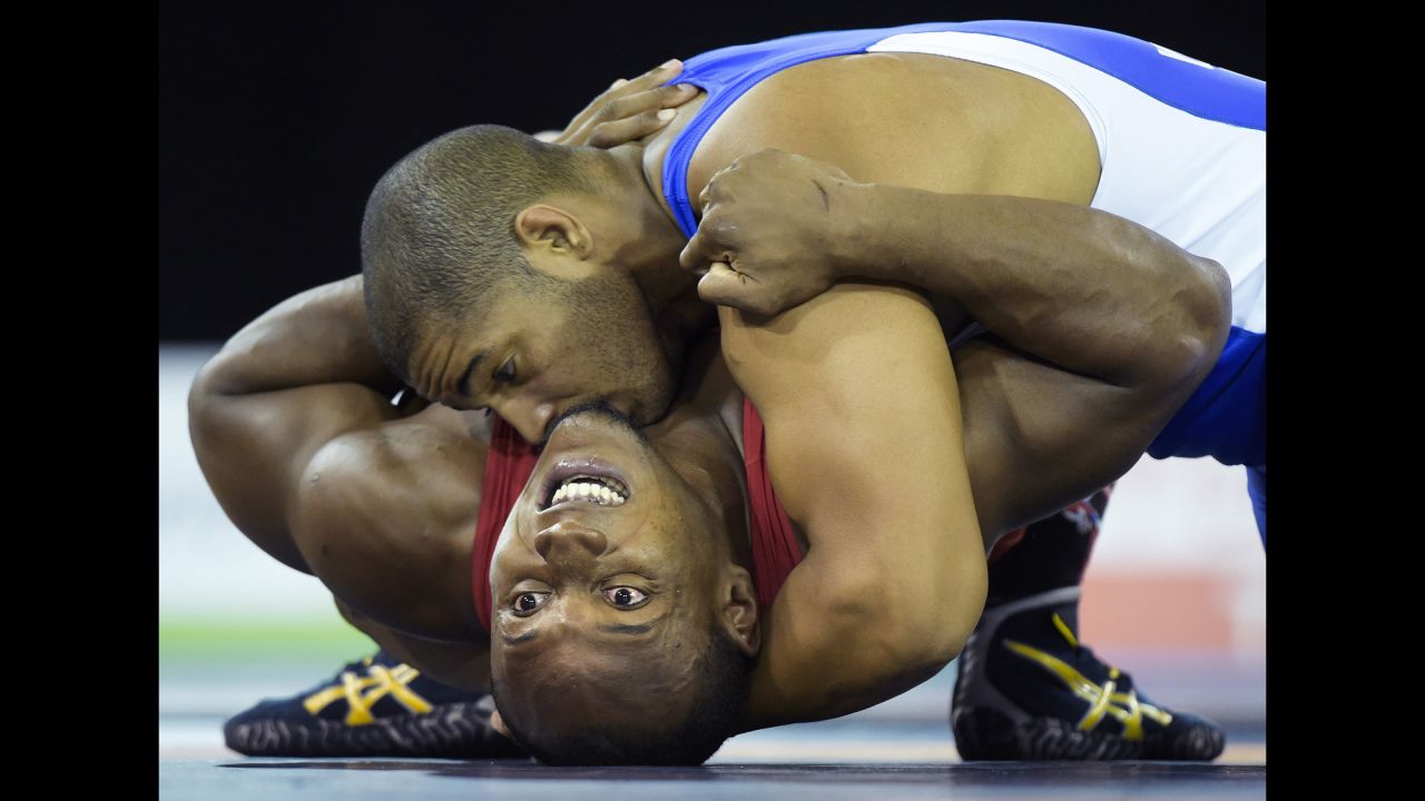 Cuba's Yasmany Lugo, top, pins down Kevin Mejia of Honduras during a Greco-Roman wrestling match Thursday, July 16, at the Pan American Games. Lugo won the gold medal in his weight class.