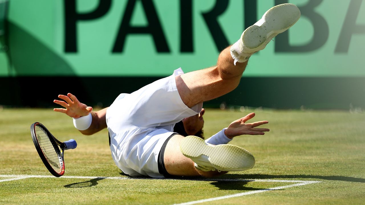 Andy Murray falls while playing Gilles Simon in a Davis Cup quarterfinal match Sunday, July 19, in London. Murray won the match in four sets, helping Great Britain advance to the semifinals for the first time since 1981.