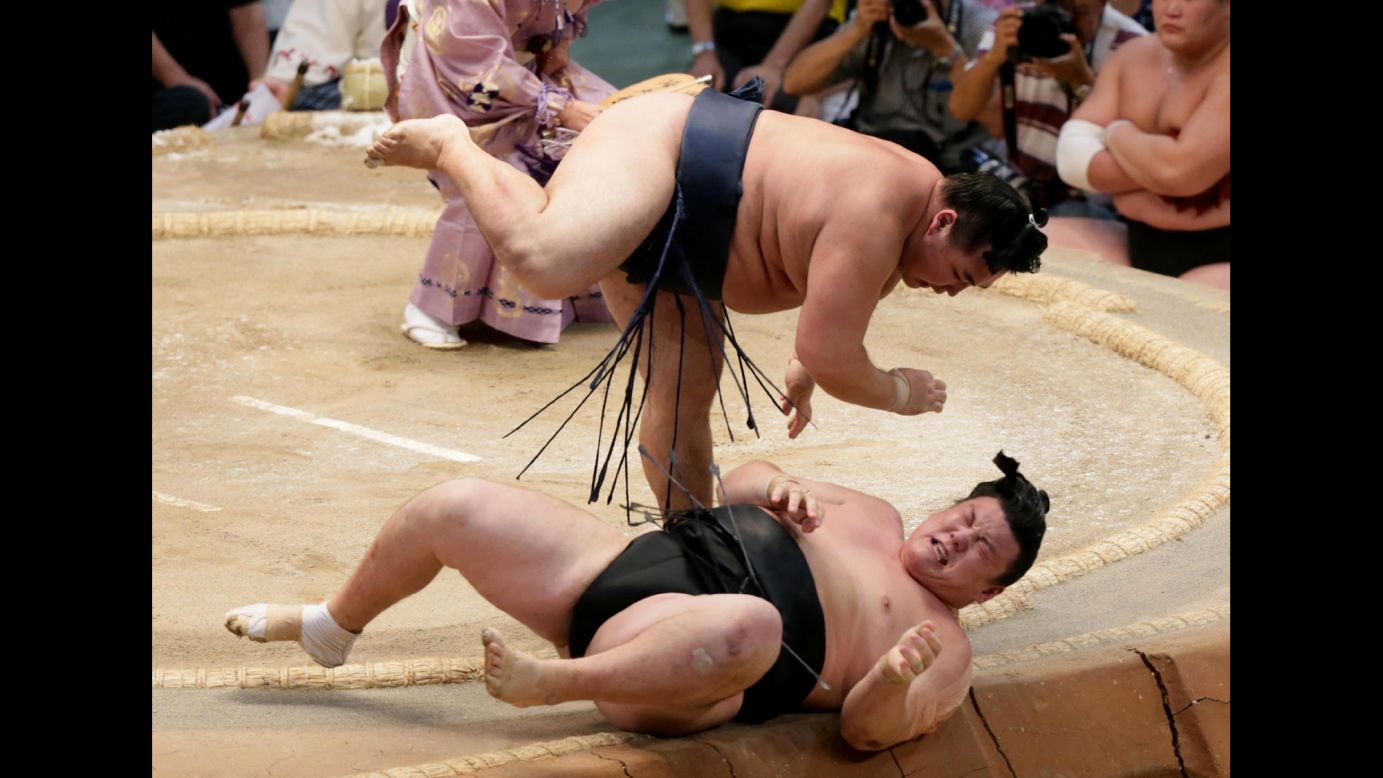 Sumo wrestler Kakuryu, top, throws Ikioi during the Grand Sumo Tournament in Nagoya, Japan, on Sunday, July 19.