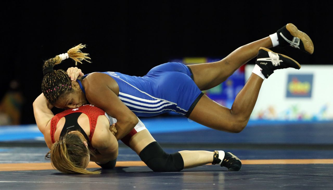Cuba's Yamilka Del Valle, top, wrestles Canada's Brianne Barry at the Pan American Games on Thursday, July 16.
