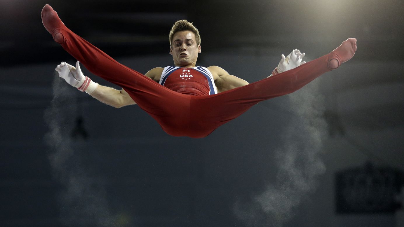 Trails of chalk follow the hands of U.S. gymnast Sam Mikulak as he rises above the horizontal bar Wednesday, July 15, at the Pan American Games.