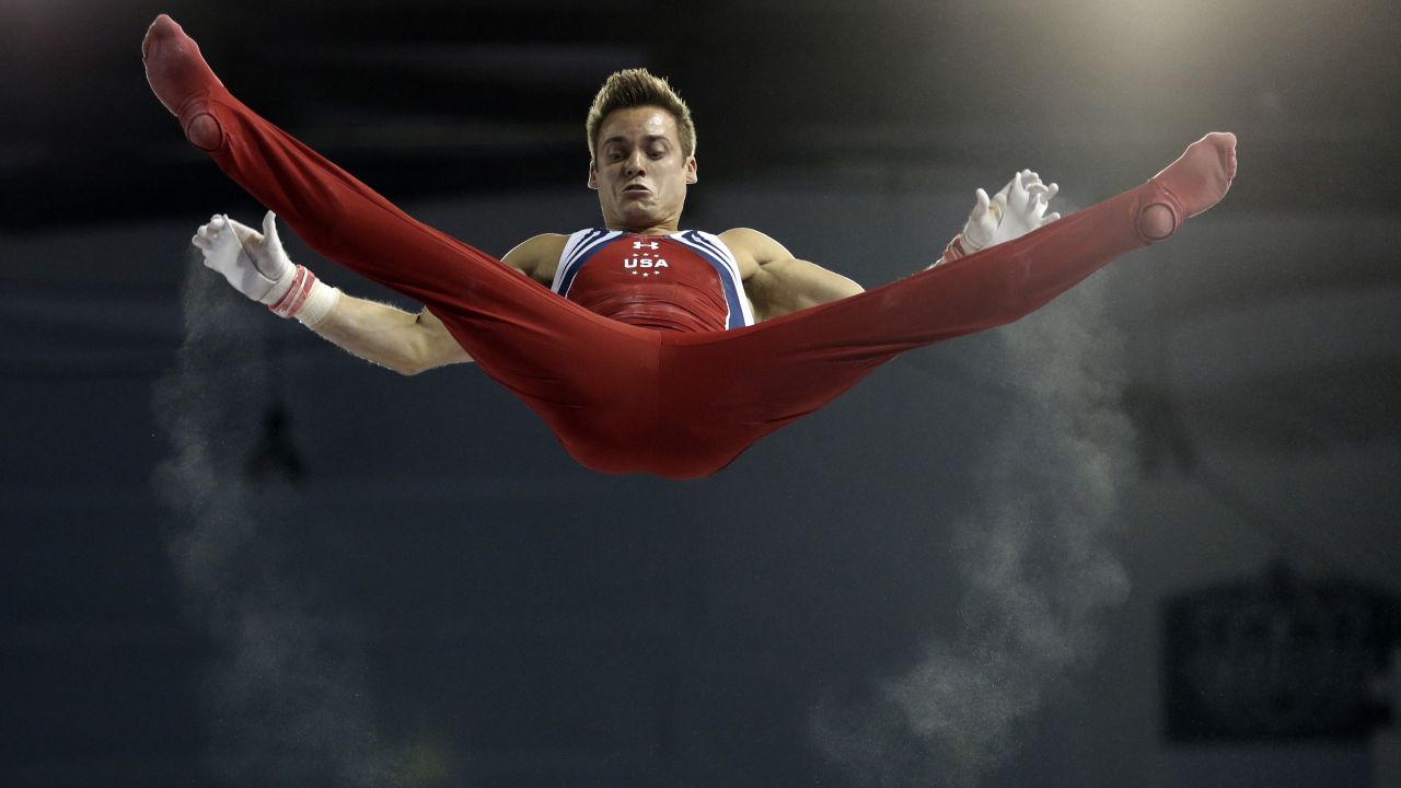 Trails of chalk follow the hands of U.S. gymnast Sam Mikulak as he rises above the horizontal bar Wednesday, July 15, at the Pan American Games.