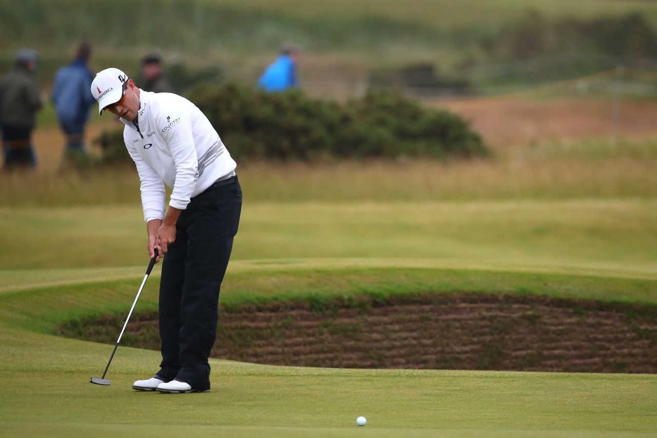 Here Johnson putts on the 14th green during the final round on The Old Course. The Open carries a $10,000,000 purse.