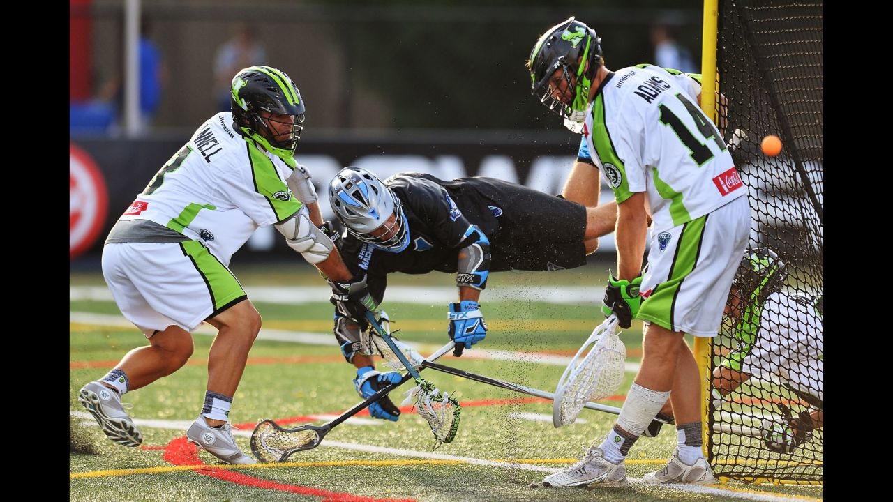 Goalie Drew Adams of the New York Lizards makes a save on Marcus Holman of the Ohio Machine during a Major League Lacrosse game Saturday, July 18, in Delaware, Ohio.