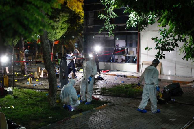 Forensic teams and police officers work at the site of <a href="index.php?page=&url=http%3A%2F%2Fwww.cnn.com%2F2015%2F07%2F20%2Fworld%2Fturkey-suruc-explosion%2Findex.html" target="_blank">a bomb attack</a> in Suruc, Turkey, on Monday, July 20. More than 30 people were killed and at least 100 others were wounded in what Turkish officials called a terrorist attack.