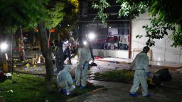 Forensic teams and police officers work at the site of a bomb attack on Monday, July 20, in Suruc, Turkey.