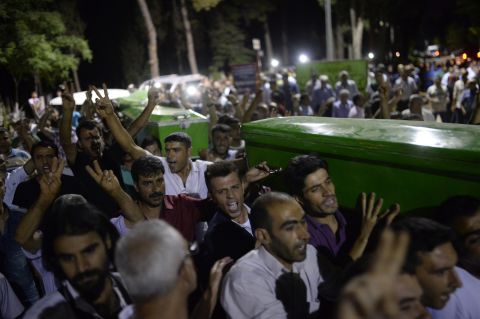 People carry victims' coffins through the streets of Gaziantep, Turkey, on July 20.