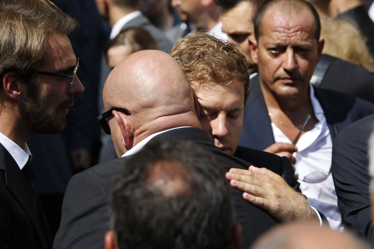 Sebastian Vettel (right) helped carry Bianchi's coffin. Here he hugs Philippe Bianchi, the father of Jules Bianchi.