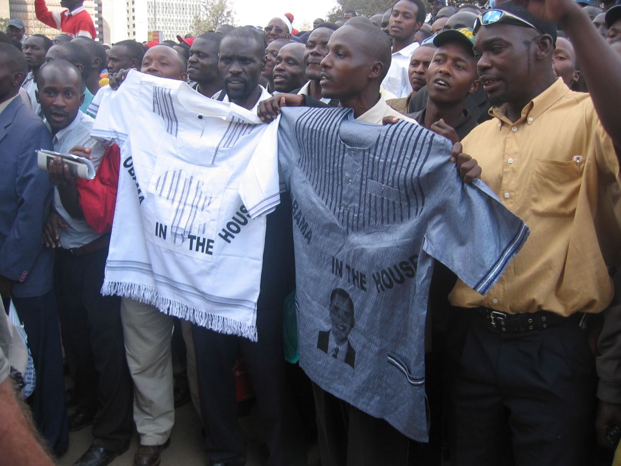 The Obama brand was popular across Africa, too, with these admirers holding up shirts as they watched Obama pass.