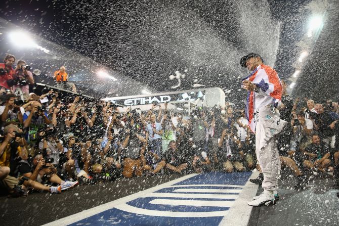 As a photographer, Thompson is always looking for a show of emotion from the driver. "Lewis Hamilton is pretty good, he's always happy to win," he says. This photo sees Hamilton celebrating finally winning the 2014 World Championship at the Abu Dhabi Grand Prix.
