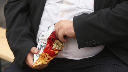 LEIPZIG, GERMANY - MAY 23: A man with a large belly eats junk food on May 23, 2013 in Leipzig, Germany. According to statistics a majority of Germans are overweight and are comparatively heavier than people in most other countries in Europe. (Photo by Sean Gallup/Getty Images) 