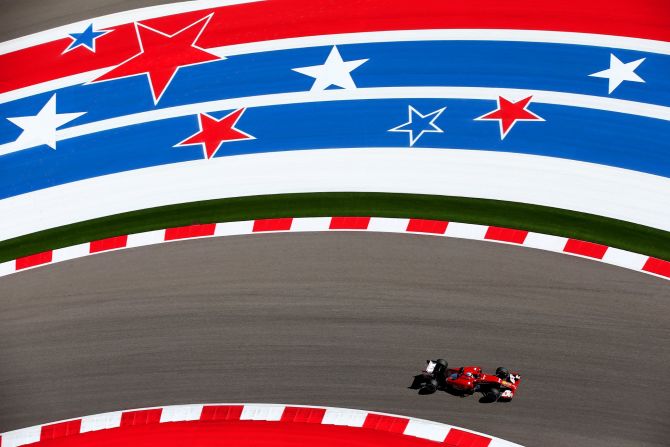 Fernando Alonso, driving for Ferrari in 2014, glides through the star and stripes at Austin's Circuit of the Americas but getting a different angle is challenging for an F1 photographer.  "I climbed a tree once in Brazil for a shot through the leaves," Thompson reveals.