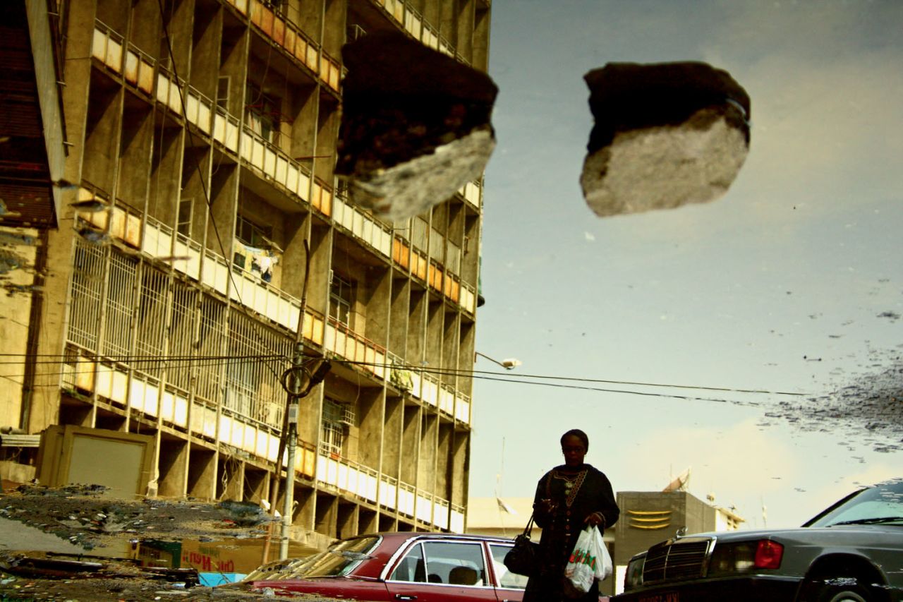 Kiripi Katembo uses photography and video to explore the urban environment. In 2009, he made the photographic series Un Regard, which depicts gritty Kinshasa through puddles. (Pictured: Subir, 2011)
