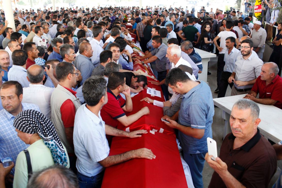 Turks mourn over coffins during a funeral for Suruc attack victims. 