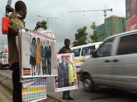 Street vendors show photos of Obama, first lady Michelle Obama and Kenya's President Uhuru Kenyatta to passing motorists in Nairobi.