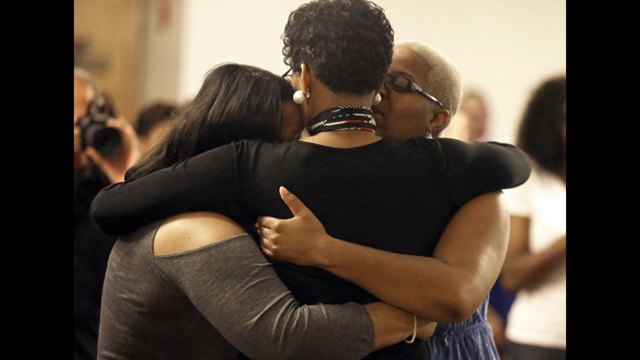 Geneva Reed-Veal, Bland's mother, hugs family members at a memorial service for her daughter July 21 in Prairie View. 