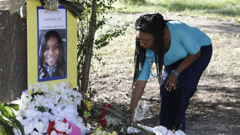 Jeanette Williams places a bouquet of roses at a memorial for Sandra Bland near Bland's alma mater, Prairie View A&M University, in Prairie View, Texas, on Tuesday, July 21. 
