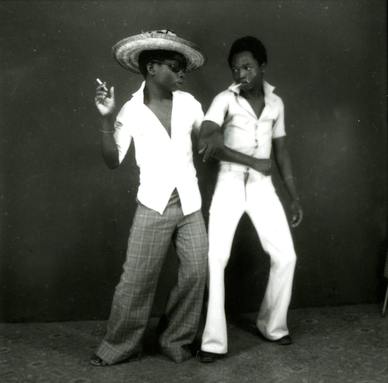Ambroise Ngaimako fled war in Angola and settled in Kinshasa where he eventually opened Studio 3Z. He mainly photographed young men -- athletes or sapeurs -- but became known for his innovative photography. He often printed two negatives onto the same paper, or duplicated images using the same negative -- a novel approach at the time. (Pictured: Euphorie de deux jeunes qui se retrouvent, 1972)